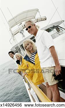 Stock Photo - mature couple 
and young couple 
stand on the deck 
of a sailboat. 
fotosearch - search 
stock photos, 
pictures, images, 
and photo clipart