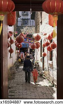 Picture - rear view of a 
father and son 
walking hand in 
hand down a cobbled. 
fotosearch - search 
stock photos, 
pictures, images, 
and photo clipart