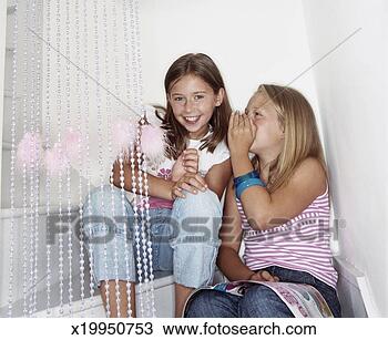 Stock Photo - two girls sitting 
on stairs, one 
girl whispering 
to other girl. 
fotosearch - search 
stock photos, 
pictures, images, 
and photo clipart