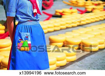Stock Photo - woman in uniform 
standing in front 
of rows of cheese, 
 alkmaar. fotosearch 
- search stock 
photos, pictures, 
images, and photo 
clipart