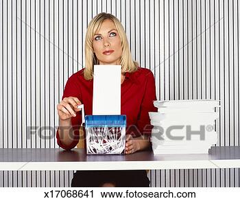 Stock Photography - young businesswoman 
sits at a table 
looking bored 
and turning the. 
fotosearch - search 
stock photos, 
pictures, images, 
and photo clipart