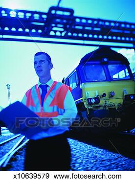 Stock Photograph - driver inspector 
stands on railway 
sidings with a 
freight train. 
fotosearch - search 
stock photos, 
pictures, images, 
and photo clipart