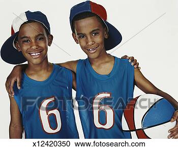 Stock Photography - studio portrait 
of twin brothers 
in sports strips 
with arms around. 
fotosearch - search 
stock photos, 
pictures, images, 
and photo clipart