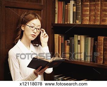 Stock Photo - intelligent looking 
woman reading 
a book in an old 
fashioned study. 
fotosearch - search 
stock photos, 
pictures, images, 
and photo clipart