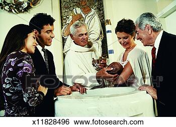 Stock Photo - parents and grandparents 
holding a baby 
stand around a 
baptismal. fotosearch 
- search stock 
photos, pictures, 
images, and photo 
clipart