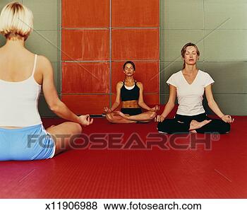Stock Photo - three women sit 
meditating in 
the lotus position, 
yoga exercise. 
fotosearch - search 
stock photos, 
pictures, images, 
and photo clipart