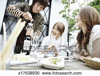 Stock Photography - young man using 
a bottle opener 
to open a bottle 
of red wine for 
his. fotosearch 
- search stock 
photos, pictures, 
images, and photo 
clipart