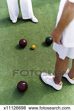 Stock Photo - elevated view 
of two people 
standing around 
three bowling 
balls and a. fotosearch 
- search stock 
photos, pictures, 
images, and photo 
clipart
