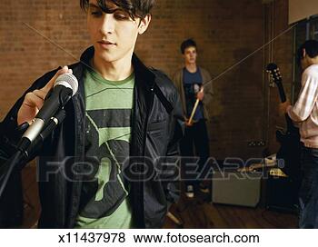 Stock Photo - three boys in 
a studio, one 
boy tapping a 
microphone. fotosearch 
- search stock 
photos, pictures, 
images, and photo 
clipart