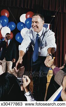 Stock Photo - american politician 
shaking hands 
with supporters 
at a political 
rally. fotosearch 
- search stock 
photos, pictures, 
images, and photo 
clipart