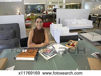 Stock Photograph - female interior 
designer sits 
at a table in 
an interiors shop. 
fotosearch - search 
stock photos, 
pictures, images, 
and photo clipart