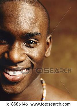 Stock Image - cropped close-up 
of a smiling young 
man with a shaved 
head. fotosearch 
- search stock 
photos, pictures, 
images, and photo 
clipart