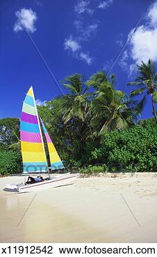 Stock Photo - man lying on his 
sailing boat at 
st james beach, 
barbados, caribbean. 
fotosearch - search 
stock photos, 
pictures, images, 
and photo clipart