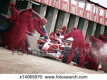 Stock Photography - tilted shot of 
a pit crew mechanics 
fuelling a formula 
one racing car. 
fotosearch - search 
stock photos, 
pictures, images, 
and photo clipart