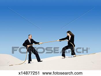 Stock Photography - businessman and 
businesswoman 
playing tug of 
war in a desert. 
fotosearch - search 
stock photos, 
pictures, images, 
and photo clipart