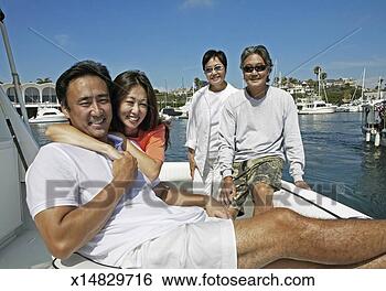 Stock Photo - couple and their 
parents sit on 
the deck of a 
sailing boat in 
a. fotosearch 
- search stock 
photos, pictures, 
images, and photo 
clipart