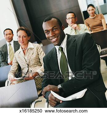 Stock Photography - group of business 
people sitting 
in a conference 
room listening 
to a. fotosearch 
- search stock 
photos, pictures, 
images, and photo 
clipart