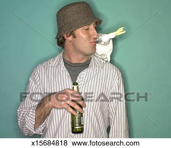 Stock Photo - young man holding 
a beer bottle 
kissing a cockatoo. 
fotosearch - search 
stock photos, 
pictures, images, 
and photo clipart