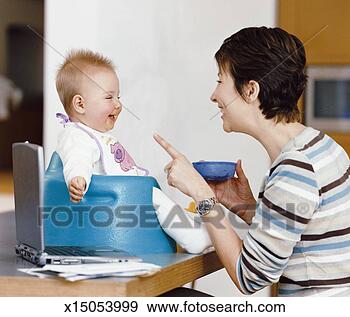 Stock Photograph - mother holds a 
bowl of baby food, 
 talking and smiling 
at her baby in. 
fotosearch - search 
stock photos, 
pictures, images, 
and photo clipart