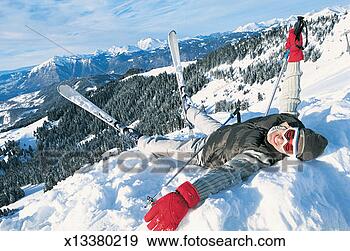 Stock Photograph - smiling man lying 
down in his skis 
on a ski slope. 
fotosearch - search 
stock photos, 
pictures, images, 
and photo clipart