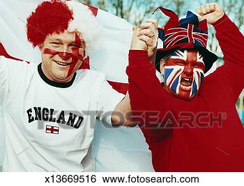 Stock Photo - two male supporters 
with british flags 
painted on their 
faces holding. 
fotosearch - search 
stock photos, 
pictures, images, 
and photo clipart