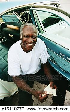 Picture - man sitting in 
the back seat, 
cleaning an old 
fashioned car. 
fotosearch - search 
stock photos, 
pictures, images, 
and photo clipart