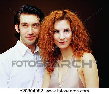 Stock Photo - portrait of a 
woman with long 
red hair beside 
a man with long 
black. fotosearch 
- search stock 
photos, pictures, 
images, and photo 
clipart