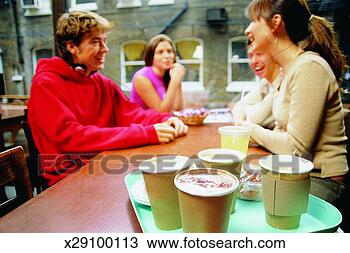 Stock Photo - tray of coffees 
in a coffee shop 
and young people 
sitting and. fotosearch 
- search stock 
photos, pictures, 
images, and photo 
clipart