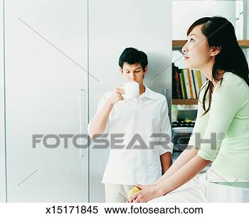 Stock Image - young couple ignoring 
each other, domestic 
interior. fotosearch 
- search stock 
photos, pictures, 
images, and photo 
clipart