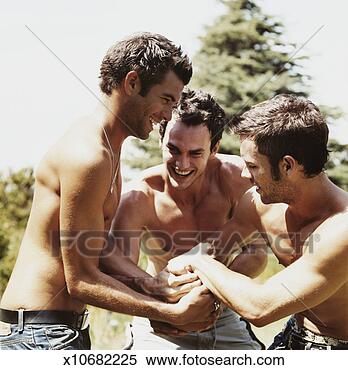 Stock Image - half dressed young 
men bonding in 
a garden. fotosearch 
- search stock 
photos, pictures, 
images, and photo 
clipart