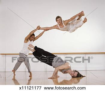 Picture - male dancers supporting 
on another male 
dancer with his 
arms raised. fotosearch 
- search stock 
photos, pictures, 
images, and photo 
clipart