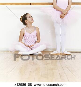 Stock Photo - seated young ballet 
dancer looking 
up at another 
ballet dancer. 
fotosearch - search 
stock photos, 
pictures, images, 
and photo clipart