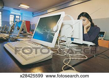 Stock Photograph - female university 
student using 
a computer in 
a an empty computer 
room. fotosearch 
- search stock 
photos, pictures, 
images, and photo 
clipart