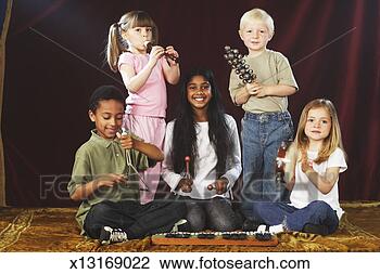 Stock Photo - group of children 
(4-9) performing 
on stage with 
musical instruments. 
fotosearch - search 
stock photos, 
pictures, images, 
and photo clipart