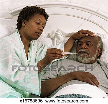 Stock Photo - senior woman taking 
senior man's temperature 
in bed. fotosearch 
- search stock 
photos, pictures, 
images, and photo 
clipart