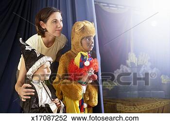 Stock Photo - teacher standing 
with children 
(4-8) in costumes 
behind stage curtain. 
fotosearch - search 
stock photos, 
pictures, images, 
and photo clipart