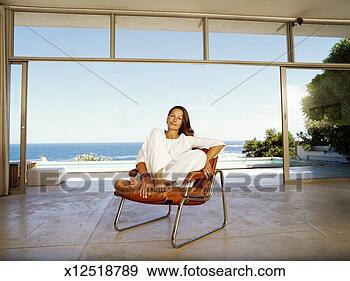 Stock Photograph - mature woman on 
chair indoors 
by ocean, portrait. 
fotosearch - search 
stock photos, 
pictures, images, 
and photo clipart