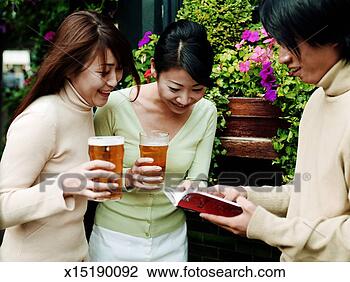 Stock Photo - two young women 
and young man 
outside pub, women 
holding pints 
of beer. fotosearch 
- search stock 
photos, pictures, 
images, and photo 
clipart