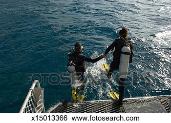 Stock Photo - couple jumping 
off back of boat 
wearing scuba 
diving equipment. 
fotosearch - search 
stock photos, 
pictures, images, 
and photo clipart
