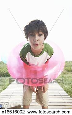 Stock Photo - boy (8-10) with 
rubber ring around 
shoulders,  making 
facial. fotosearch 
- search stock 
photos, pictures, 
images, and photo 
clipart