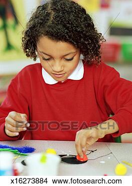 Stock Photo - schoolgirl (5-7) 
making collage 
from arts and 
crafts materials. 
fotosearch - search 
stock photos, 
pictures, images, 
and photo clipart