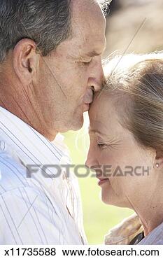 Stock Photo - mature man kissing 
mature woman on 
forehead, close-up. 
fotosearch - search 
stock photos, 
pictures, images, 
and photo clipart