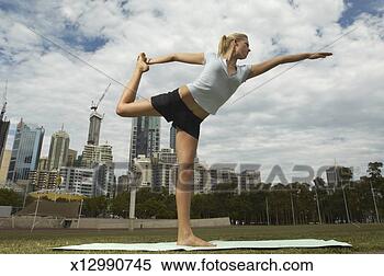 Stock Image - young woman performing 
shiva posture, 
low angle. fotosearch 
- search stock 
photos, pictures, 
images, and photo 
clipart