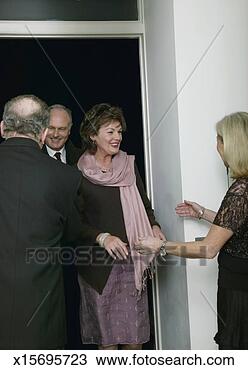 Stock Photo - mature couple 
arriving at mature 
couple's house, 
smiling. fotosearch 
- search stock 
photos, pictures, 
images, and photo 
clipart