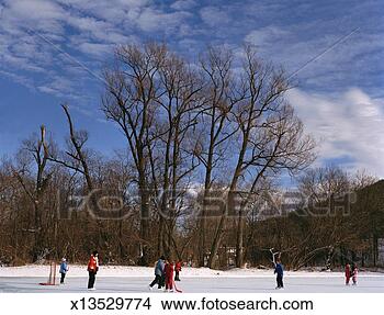 Stock Photo - children playing 
ice hockey on 
frozen pond, winter. 
fotosearch - search 
stock photos, 
pictures, images, 
and photo clipart