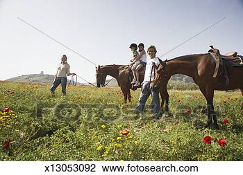 Stock Photo - mother leading 
son and daughter 
(9-11) on horse 
by father and 
horse. fotosearch 
- search stock 
photos, pictures, 
images, and photo 
clipart