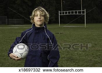 Stock Photo - boy (10-12) holding 
soccer ball on 
soccer field, 
portrait. fotosearch 
- search stock 
photos, pictures, 
images, and photo 
clipart