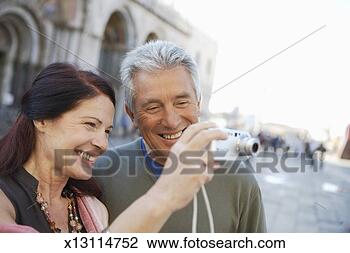 Stock Photo - italy, venice, 
mature couple 
using camera, 
smiling (focus 
on couple). fotosearch 
- search stock 
photos, pictures, 
images, and photo 
clipart