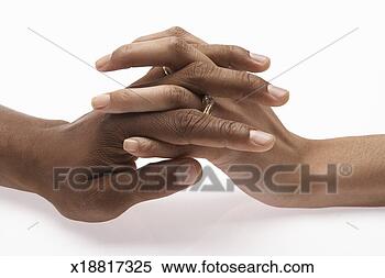 Stock Image - man and woman 
holding hands, 
wearing wedding 
rings (focus on 
hands). fotosearch 
- search stock 
photos, pictures, 
images, and photo 
clipart