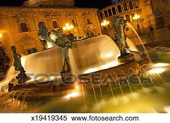 Stock Image - spain, valencia, 
fountain in cathedral 
square, dusk (blurred 
motion). fotosearch 
- search stock 
photos, pictures, 
images, and photo 
clipart